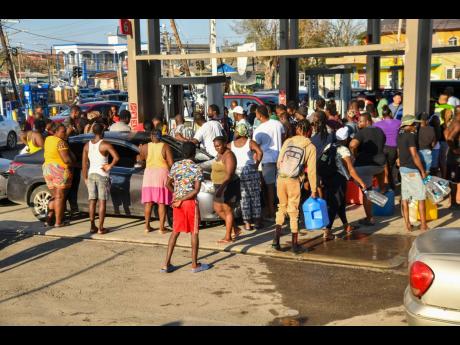 Residents scramble to get gasolene for their vehicles, generators and the like at Total gas station, Savanna-la-Mar, Westmoreland, on October 31. 