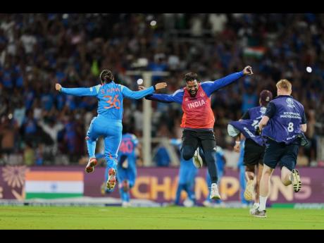 India’s Sneh Rana (left) and a team support staff celebrate after winning the ICC Women’s Cricket World Cup final match between India and South Africa in Navi Mumbai, India, yesterday.