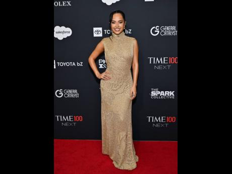 Becky G leans into her signature golden allure in an AMIRI Fall 2025 mock-neck knit dress.