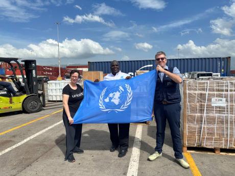 Credit: Contributed From left: Olga Isaza, representative, UNICEF Jamaica; Dennis Zulu, UN resident coordinator; and Brian Bogart, representative and country Director, World Food Programme (WFP) were on site at the Kingston Freeport Terminal to oversee the offloading of criti