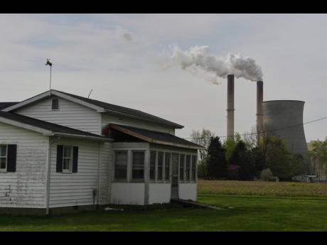 A home sits near a coal-fired power plant, April 14, 2025, in Cheshire, Ohio.