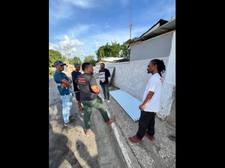 Rajae Danvers, founder and executive director of the Spread Love Initiative, in partnership with Alfrasure Structures and Roofing Limited, donated supplies to members of the Maxfield Avenue community.