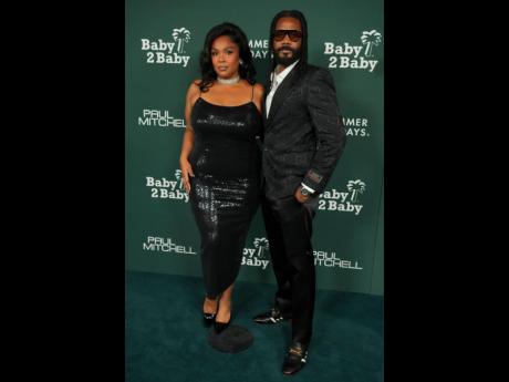 Credit: AP Lizzo brings her beau Myke Wright as her plus-one for the evening.