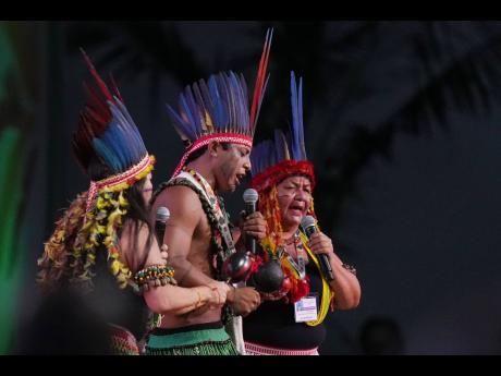 Indigenous peoples perform at a plenary session at the COP30 UN Climate Summit in Belem, Brazil, on November 10.