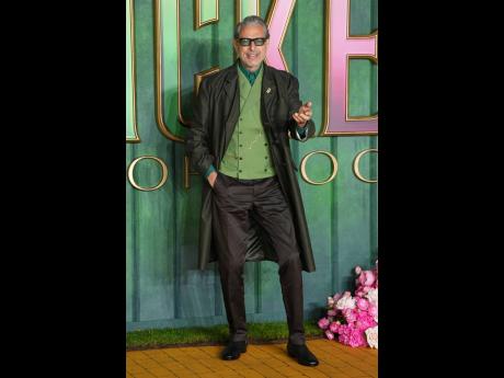 Jeff Goldblum, the Wizard of Oz in ‘Wicked’ sequel, turns heads in a brown Prada coat layered over a green vest and brown chinos, finished with sleek black shoes.