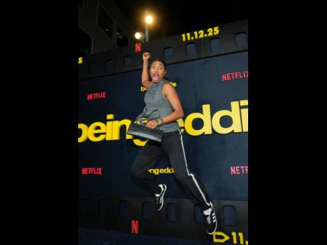 Credit: AP Basketball player Angel McCoughtry is caught in a dunk pose on the blue carpet.