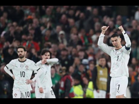 Portugal's Cristiano Ronaldo, right, leaves the pitch after being shown a red card during a World Cup 2026 group F qualifying soccer match between Ireland and Portugal in Dublin, Thursday, November 13, 2025. (AP Photo/Peter Morrison)