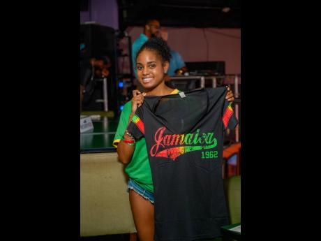 Crystal Davis, daughter of Beenie Man and Carlene Smith, beams with pride after snagging a Jamaica T-shirt prize ahead of the Reggae Boyz game.