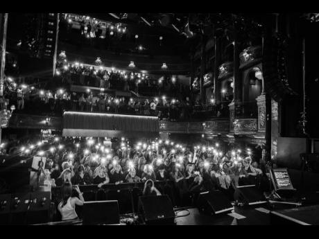 The audience remains fully engaged, moving in rhythm with the music and the message and capturing every moment.