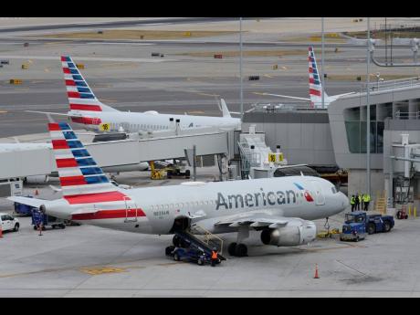 American Airlines planes sit on the tarmac at LaGuardia Airport, January 11, 2023, in New York.