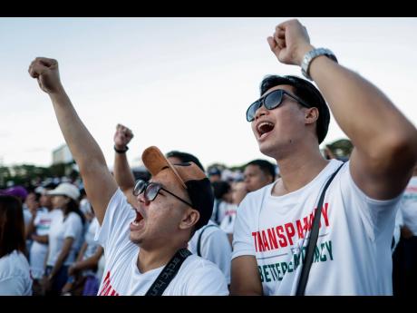 Members of the religious sect Iglesia Ni Cristo (Church of Christ) shout slogans during a three-day anti-corruption rally at Manila’s Rizal Park, Philippines.