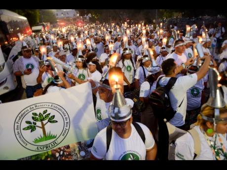 Activists during the ‘Porongaço’ march of the Forest Peoples. The name ‘Porongaço’ comes from the poronga, the oil lamp used by rubber tappers during their night work in the forest.