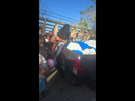 Sonya Hall, administrative and training coordinator at the Caribbean Shipping Association, distributes relief supplies to residents in communities impacted by Hurricane Melissa as part of the maritime sector’s continued support for national recovery effo