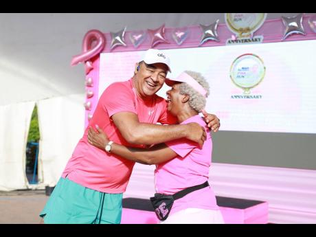 Credit: Contributed Dr Christopher Tufton, minister of health and wellness, congratulates Sandra Samuels, president of JR2R, on a successful 25th anniversary staging of Pink Run.