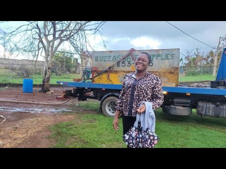 A satisfied smile from Waltham Abbey Primary School Principal Rosa Gallimore Pyne, who breathes a sigh of relief as water is delivered to the St Ann school by Discovery Bauxite, in time for her school reopening. The bauxite company’s water wells have bee