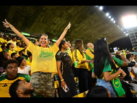Credit: Gladstone Taylor A buoyant Yendi Phillipps reps Jamaica in a yellow Represent Jamaica mesh jersey, paired with camo cargo pants.