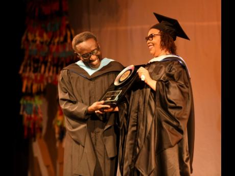 Credit: Antoine Lodge Comedian and educator Owen ‘Blakka’ Ellis soaks in the moment during his Lifetime Achievement award presentation at the Edna Manley College graduation, while Dorrett Campbell, principal, looks on.