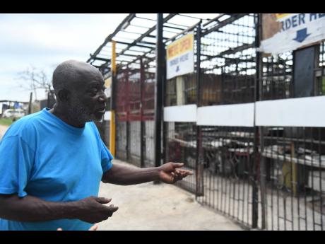 Rudolph ‘Howie’ Valentine Salmon looks at his once-thriving roadside kitchen nicknamed ‘100 Pot’ in Middle Quarters.