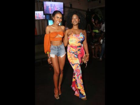 Credit: Nathaniel Stewart Medical student and model Titania Mycko (left), Miss Intercontinental Jamaica 2023, is ready to take in the performances in an orange crop top and micro denim shorts, joined by her friend Davea Atkinson, CEO of Faulty Streetwear, who is rocking florals.