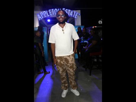 Credit: Nathaniel Stewart Ras-I smiles for the camera before hitting the stage in camo cargo pants and a relaxed polo.