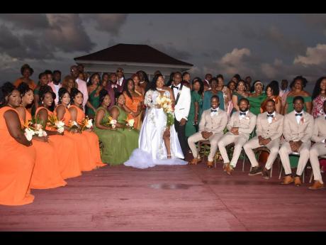 The newly-weds (centre) share lens time with their wedding party, family and friends at the Waters Edge Guest House in Unity Hall, St James. 