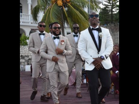 Groom Jevaughn Gaynor (front) makes a lively entrance, dancing down the aisle with his groomsmen by his side.