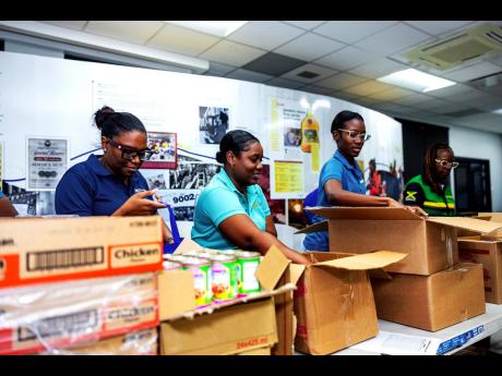 Credit: Contributed Campari staff prepare care packages for distribution to hard-hit parishes following the passage of Hurricane Melissa.