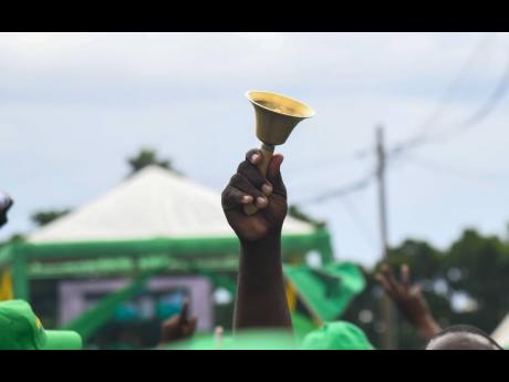 Credit: Matthew Mckoy A Jamaica Labour Party supporter rings a bell at the party's 81st Annual Conference at the National Arena in Kingston on November 24, 2024.