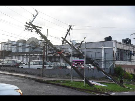 Credit: Ian Allen Toppled JPS utility poles are seen along Hargreaves Avenue in Mandeville after Hurricane Melissa swept through Jamaica last month.
