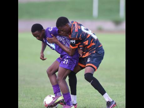 Robinho Morgan (left) of Kingston College and Horace Morgan of Tivoli High battle for the ball during their ISSA-WATA Manning Cup football match at the Stadium East field on on Wednesday, October 1. KC won 4-0.