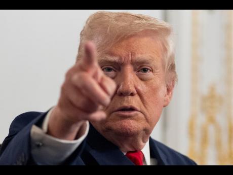 President Donald Trump speaks to reporters after speaking to troops via video from his Mar-a-Lago estate on Thanksgiving, Thursday, November 27, 2025, in Palm Beach, Florida.(AP Photo/Alex Brandon)