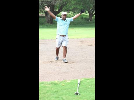 Contributed 
Paul Leyow throws his hands up in celebration after sinking a birdie to win the AMG Buccaneer Golf Tournament in dramatic fashion last Sunday at the Caymanas Golf Club in St Catherine.