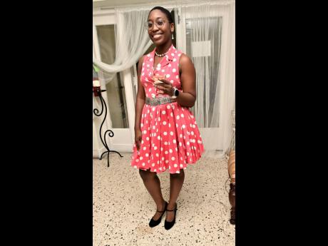 Credit: Rudolph Brown Ifa-Shani Dehaney dons a sleeveless polka-dot collared dress.