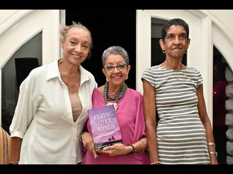 There’s no greater feeling than celebrating a sibling’s milestone, with first-time author Sandra D. Cooper (centre) flanked by her sisters, Celia McCreath (left), and Sherille Hamilton.
