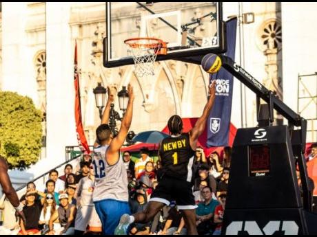 Jamaica’s Jabulani Newby (right) goes up for this lay-up in their match against the Dominican Republic at the FIBA 3x3 AmeriCup over the weekend. 