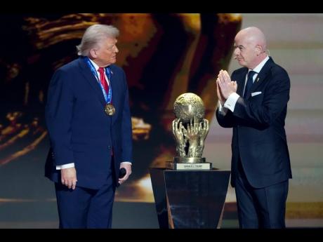 Credit: AP FIFA President Gianni Infantino (right) awards President Donald Trump with the FIFA Peace Prize during the draw for the 2026 football World Cup at the Kennedy Center in Washington yesterday.