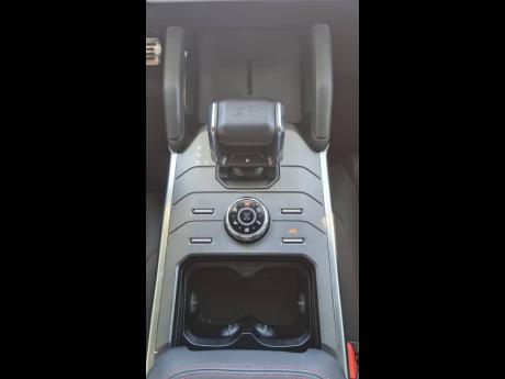 The robust central console area, featuring the tactile drive-mode selector dial and convenient surrounding controls.
