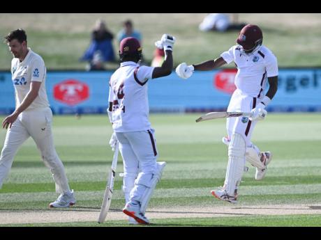 
West Indies’ Justin Greaves (right) celebrates with teammate Kemar Roach (centre) after scoring 200 runs against New Zealand on day five of their Test match in Christchurch, New Zealand, on Friday. 