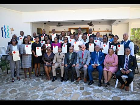 Minister of Justice and Constitutional Affairs, Delroy Chuck (seated centre), and Custos of St Mary, Errol Johnson (seated, third left), with newly minted justices of the peace of St Mary, during the commissioning ceremony held in Port Maria.
