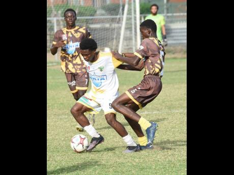 Ian Allen/photographer 
Excelsior High School’s Kimarly Scott (centre) tries to get past Charlie Smith’s Devonte Wilson during their ISSA/WATA Manning Cup quarter-final encounter at Winchester Park yesterday. Looking on is Charlie Smith’s Orlando Gra