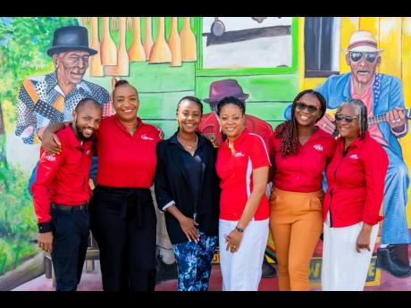 JMMB team members with Emprezz Golding, CEO of Talk Up Yout, following the CHAMP Parenting Conference.