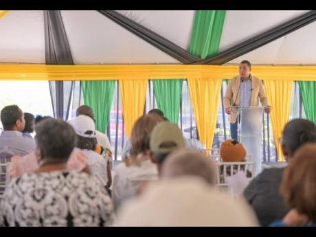 Prime Minister Dr Andrew Holness addressing a land titling ceremony at the Lacovia Community Centre in St Elizabeth on Friday, December 12, 2025.