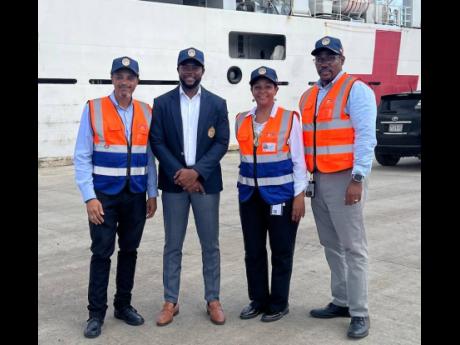 JFS Chief Executive Officer Anna Hamilton is joined on the Montego Bay Cruise Ship Pier by Chris Magnus, COSCO Shipping Line Manager (left), Mayor of Montego Bay Richard Vernon (second left), and Garth Letts, Operations Manager at JFS (right), during the a