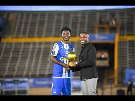 Credit: Matthew McKoy Mount Pleasant Football Academy club captain, Daniel Green, is awarded the Golden Ball after the Concacaf Caribbean Cup final against Universidad O&M at the National Stadium on December 2.