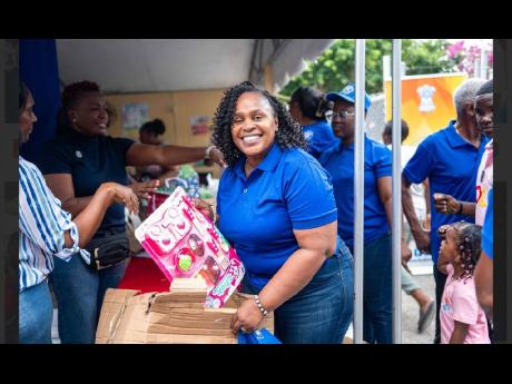 Credit: Photo by Keisha Hill Distinguished President Jacqueline Bennett, prepares to hand out gifts, as part of the Kiwanis Club of West St Andrew’s Health and Wellness Fair, held at Laura’s Basic School.