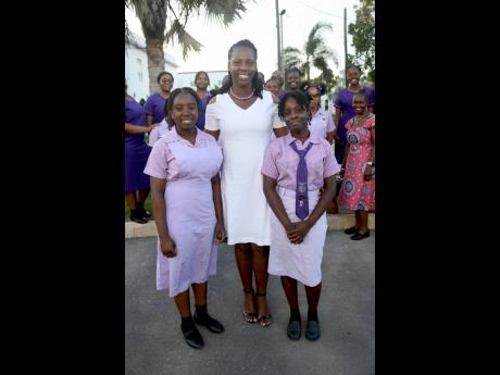 Vanessa Thompson-Walters (centre), vice principal St Hilda’s Diocesan High, is flanked by students Glenda Wilson (left) and Tasha Cummings at the Kingston College Chapel Choir annual Christmas concert.