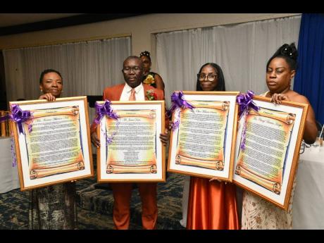 Credit: The four retired educators at the St Catherine-based Jonathan Grant High School, display their citations. They are (from left) Textbook Administrator, Ivorene Neil; Vice Principal, James Davis; Internal Examination Coordinator, Olive Simms; and Textbook Ad