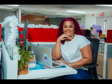 Alisha Distant paused from her work at her desk for a quick photo op.