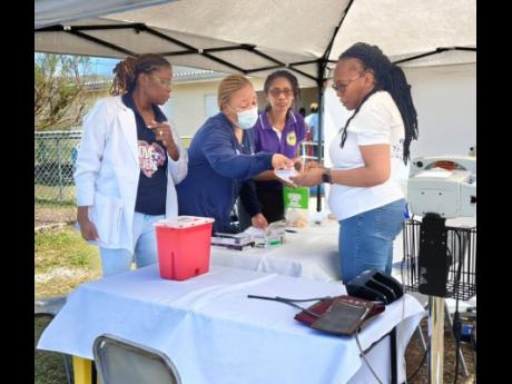 Dr Lisa Henry (second left), director of Nursing Services, Andrews Memorial Hospital Ltd, guided the triage process at the Hurricane Relief Health Clinic with Fredricka Coombs and Charmaine Blythe, laboratory manager and assistant laboratory manager at And