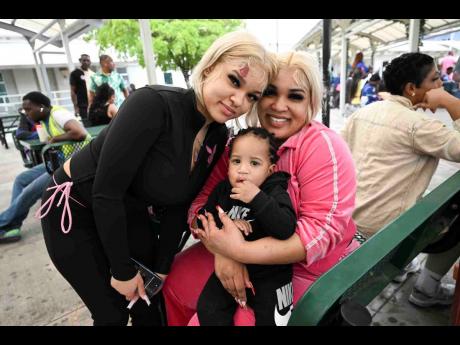 Credit: Ricardo Makyn/Chief Photo Editor Alliah Moore (left) poses for a photo with her sister Amber Moore and nephew Aiden after the trio arrived on Monday.